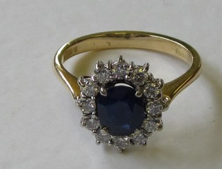 An 18ct yellow gold dress ring set a sapphire surrounded by diamonds