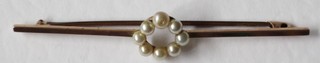 A 9ct gold bar brooch set ring of demi-pearls