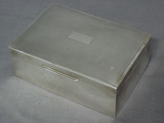 A silver cigarette box with engine turned decoration and hinged lid, 5", marks rubbed