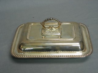 A rectangular silver plated entree dish and cover with bead work border