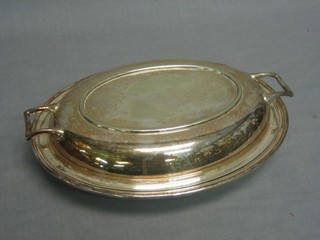 An oval silver plated twin handled entree dish and cover