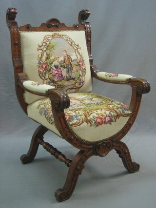 A 19th Century Italian style carved walnut X framed open arm chair with Berlin wool work seat and back