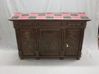 A 19th Century Continental oak dresser base with tiled top, fitted 3 drawers, carved heavily throughout 55"