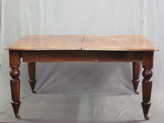 A Victorian mahogany extending dining table with 1 extra leaf, raised on turned supports 59"