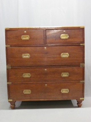 A 19th Century camphor and brass banded military secretaire chest the upper section fitted 1 short secretaire drawer and 1 other above 1 long drawer, the base fitted 2 short drawers with brass banding and counter sunk handles, raised on bun feet 40"