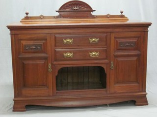 An Edwardian Art Nouveau carved walnut sideboard fitted 2 long drawers above a recess flanked by a pair of cupboards 61"