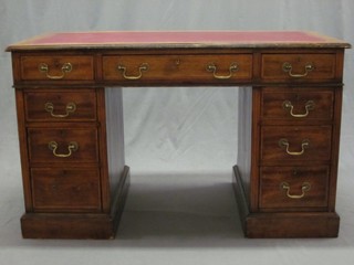 An Edwardian inlaid mahogany kneehole pedestal desk with inset red leather writing surface, the base fitted 1 long drawer flanked by 8 short drawers with brass swan neck drop handles 48"