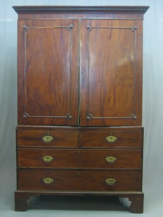 A Georgian mahogany linen press with moulded cornice, the interior fitted a hanging rail enclosed by panelled doors, the base fitted 2 short drawers above 2 long drawers, raised on bracket feet 50"