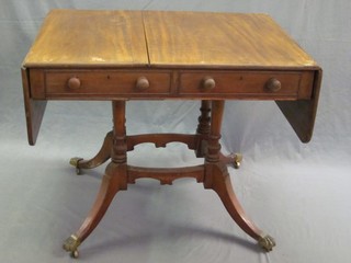 A 19th Century mahogany sofa table, fitted 2 drawers raised on 4 turned columns and outswept supports 35"