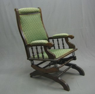 A beech framed American rocking armchair with turned decoration