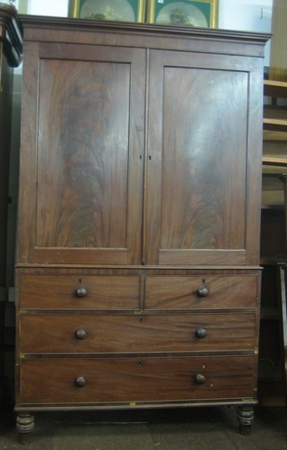A Victorian mahogany linen press with moulded cornice enclosed by panelled doors, the base fitted 2 short and 2 long drawers, raised on turned supports (no trays) 49"