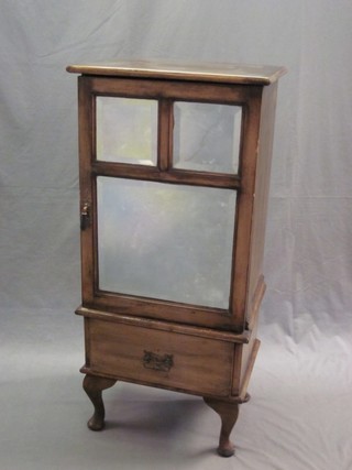 A Victorian mahogany music cabinet enclosed by bevelled mirrored  panelled doors, raised on cabriole supports 20"