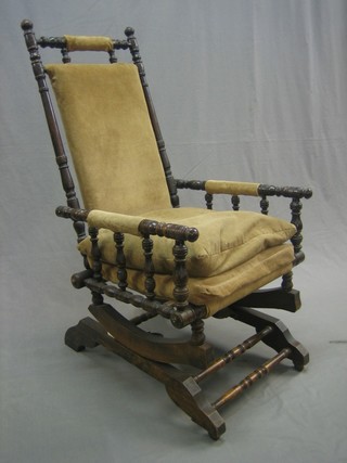 A Victorian American mahogany rocking armchair with turned decoration