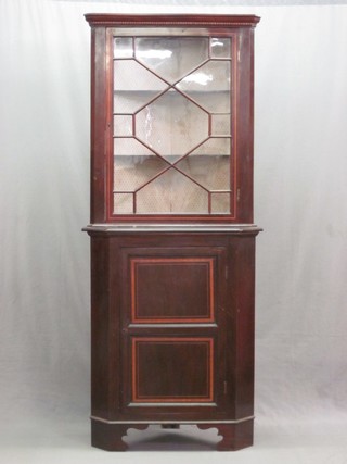 An Edwardian inlaid mahogany double corner cabinet the upper section with moulded and dentil cornice, fitted shelves enclosed by astragal glazed doors, the base fitted a cupboard enclosed by a panelled door, raised on bracket feet 33"