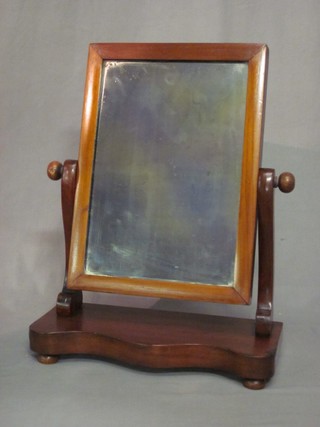 A Victorian rectangular plate dressing table mirror contained in a mahogany swing frame and raised on a shaped base 15"