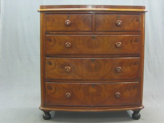 A Victorian mahogany bow front chest of 2 short and 3 long drawers with tore handles, raised on bun feet 42"