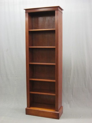 A Georgian style yew bookcase with moulded top, fitted adjustable shelves flanked by fluted columns 24"