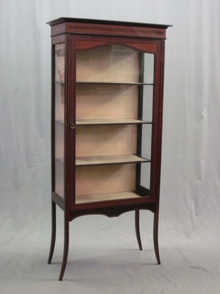 An Edwardian inlaid mahogany display cabinet, the interior fitted shelves enclosed by a glazed panelled door 27", raised on splayed feet