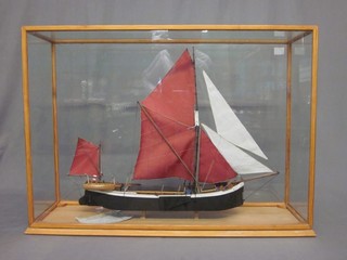 A wooden model of the barge - Lady Daphne 19" contained in a display cabinet