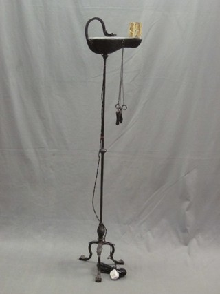 A 1920's bronze and iron Roman style standard lamp in the form of an oil lamp