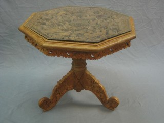 A Burmese pierced and carved hardwood occasional table, raised on pillar and tripod supports 25"