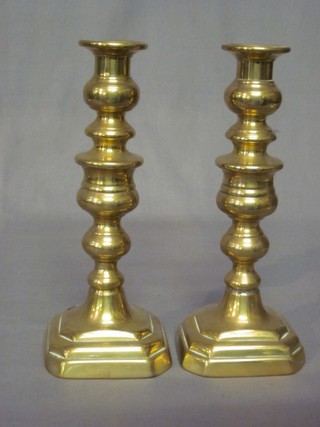 A pair of 19th Century brass candlesticks with ejectors 10" (1 with slight hole to base)