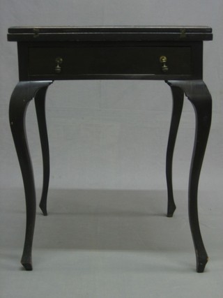 An Edwardian ebonised envelope card table fitted a drawer, raised on cabriole supports 21"