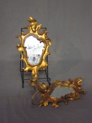 A pair of 20th Century mirrored plaques contained in gilt frames with candle sconces 12"