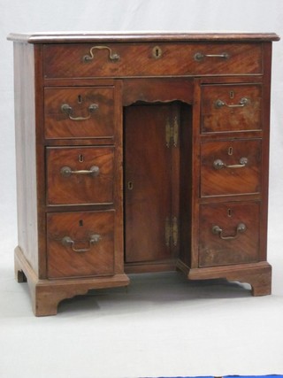 A Georgian mahogany kneehole pedestal dressing table with crossbanded top, fitted 1 long drawer, the pedestal fitted a cupboard above 1 long drawer and 6 short drawers, raised on bracket feet 30"