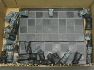 An Eastern carved hardstone chess set comprising board 7" in 2 sections complete with chess pieces
