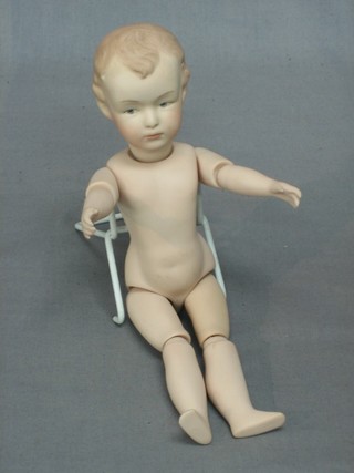 A 19th Century German biscuit porcelain figure of a boy with articulated limbs, the head inscribed Germany 9"