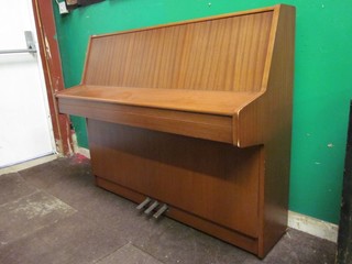 A modern upright iron framed piano forte by Kemble, contained in a teak case and with practice key 51"