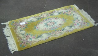 A yellow ground and floral patterned Chinese rug 61" x 31"