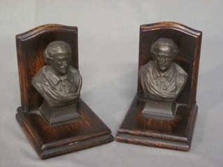 A pair of oak and spelter book ends in the form of head and shoulders busts of William Shakespeare