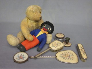 A gilt metal dressing table set, a Golliwog and a yellow mohair articulated teddy bear (missing ears)