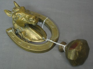 A brass door knocker in the form of a horses head together with a brass door knob