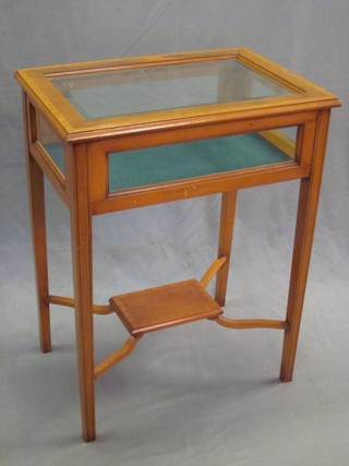 A rectangular yew bijouterie table with bevelled glass panels, raised on square tapering supports with undertier 22"