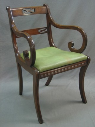 A Regency style mahogany bar back carver chair with upholstered drop in seat, raised on sabre supports