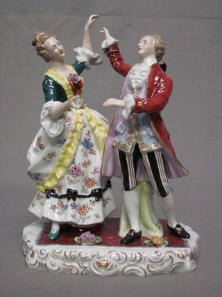 A Continental porcelain figure group of a Lady and Gentleman 9" (lady's hand f)