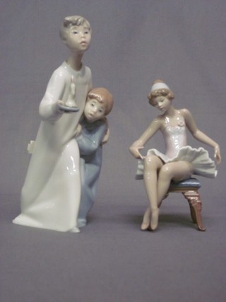 A Lladro figure - boy and girl heading to bed with chamber stick (head f and r) 9" and 1 other seated Ballerina 6"