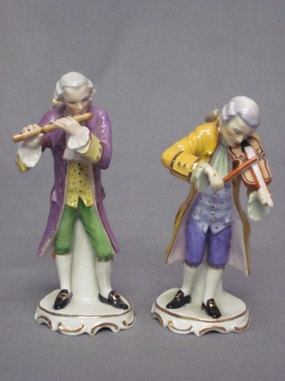 A pair of 20th Century Continental figures in the form of a Violinist and Flutist, the bases marked Kunst Kronach (both 5) 5"