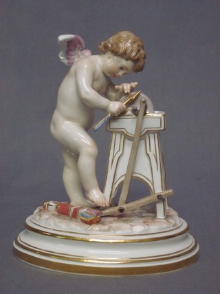 A Meissen porcelain figure in the form of a Cupid sharpening arrows, the base with crossed sword mark and impressed M14539  7"