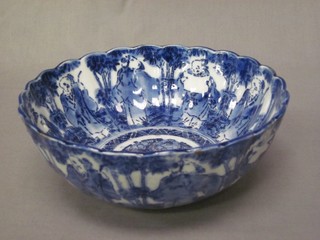 A 19th Century circular Oriental blue and white bowl with scalloped rim, decorated court figures 9"