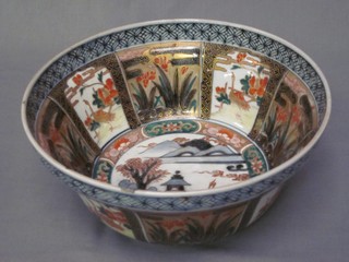 A 19th Century Japanese Imari circular porcelain bowl with panelled decoration depicting birds and temples 10"