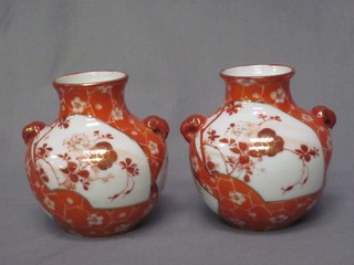 A pair of circular twin handled Kutana vases of globular form with floral decoration 4"