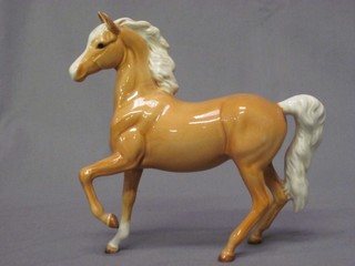 A  Beswick figure of a standing Palomino foal with left front hoof crooked 6"