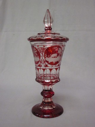 A Bohemian red etched glass jar and cover decorated deers 12"