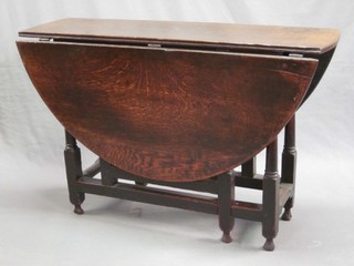 An 18th Century oval oak drop flap dining table (missing drawer) raised on turned and block supports 41"