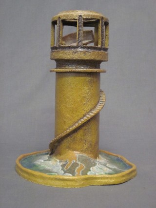 A pottery night light/oil burner in the form of a light house 13"