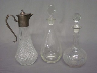 2 club shaped decanters and stoppers, a glass claret jug with plated mount and an etched glass vase decorated Sandhurst Stockholm